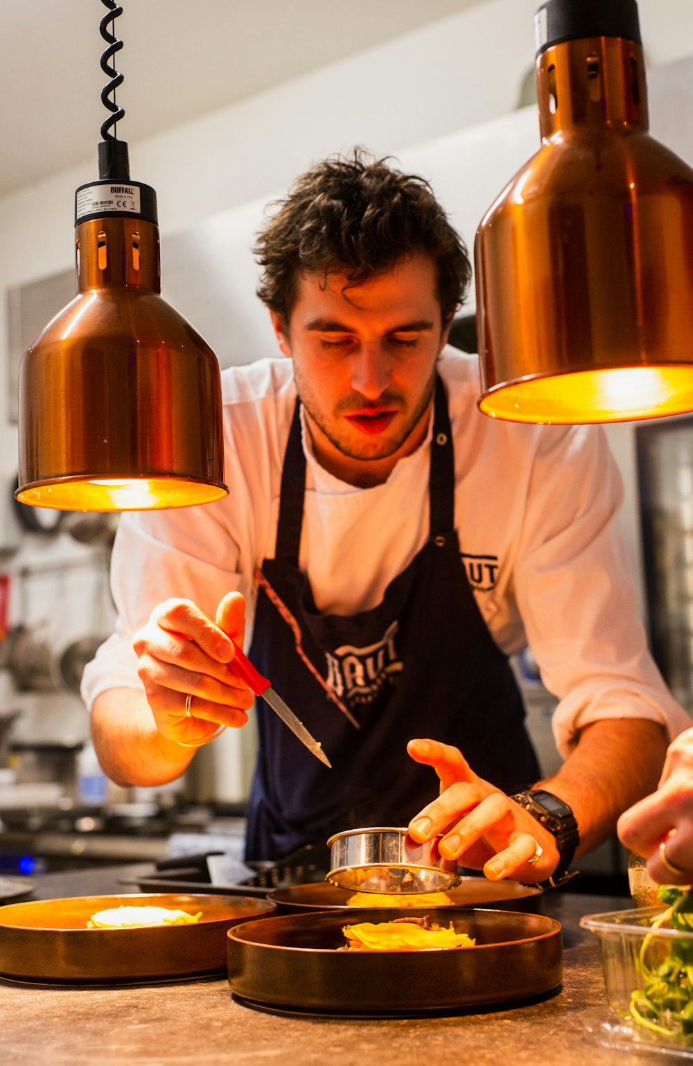 A chef plating a dish at Savoré